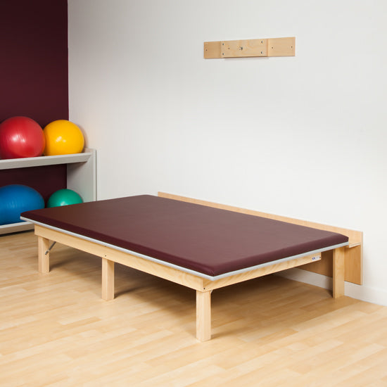 Clinton wall-mounted folding mat platform with ultra-firm padding, hardwood frame, and space-saving vertical storage design